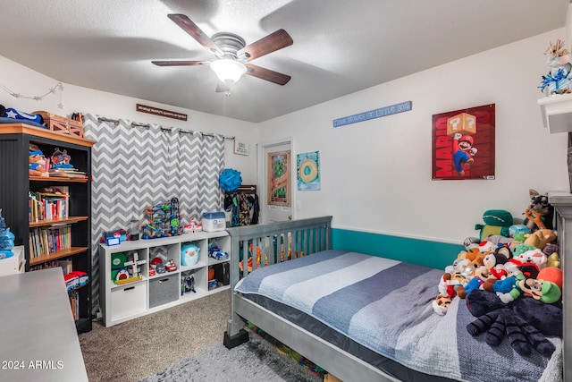 bedroom featuring ceiling fan, a textured ceiling, and carpet