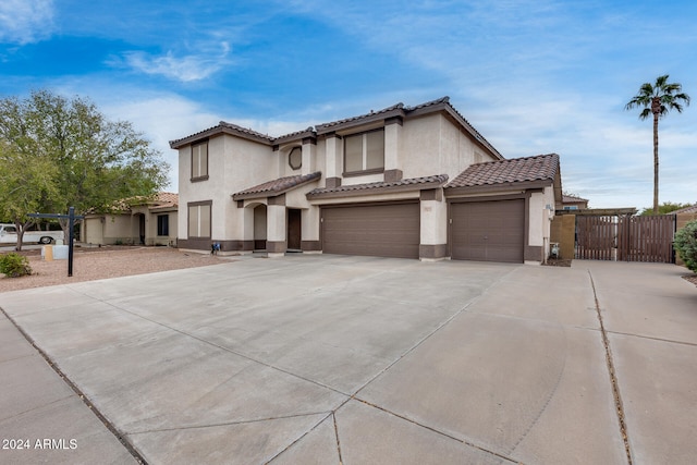 mediterranean / spanish home featuring a garage