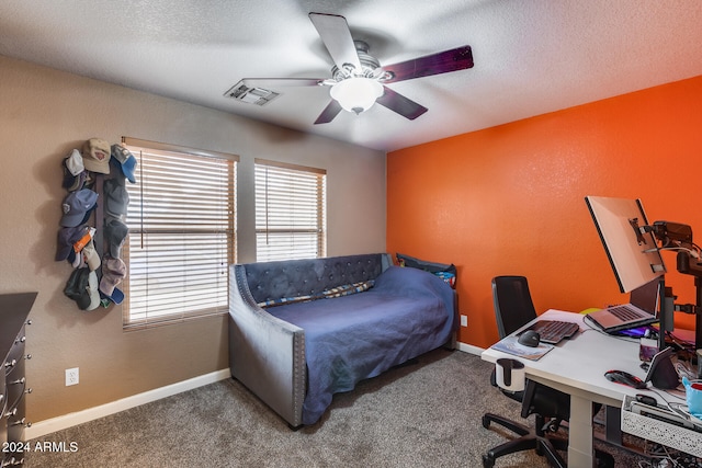 carpeted bedroom with a textured ceiling and ceiling fan