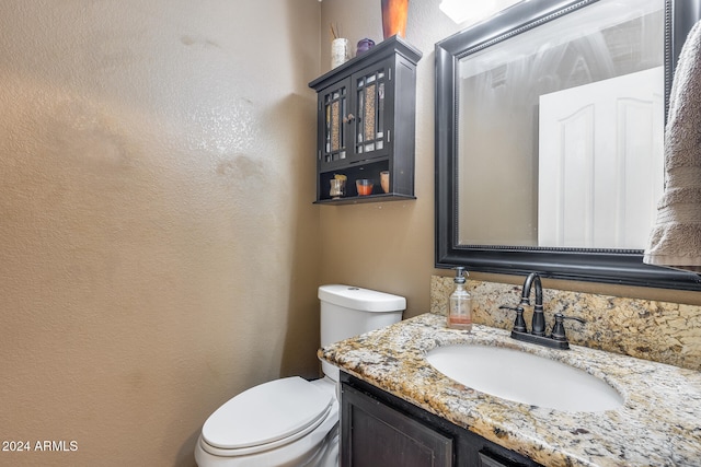 bathroom with toilet and vanity