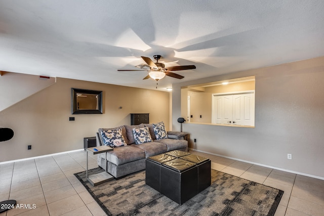 tiled living room featuring a textured ceiling and ceiling fan