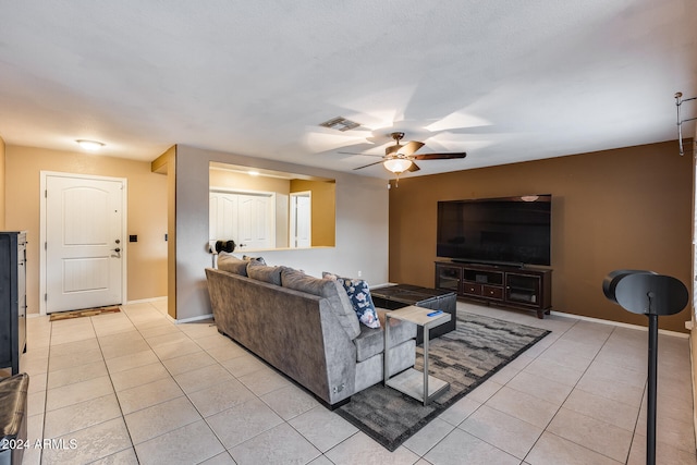 living room featuring ceiling fan and light tile patterned floors