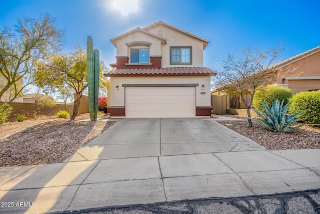 40904 N Hearst Dr, Anthem, AZ 85086 - mediterranean / spanish-style house featuring stucco siding, driveway, fence, an attached garage, and a tiled roof