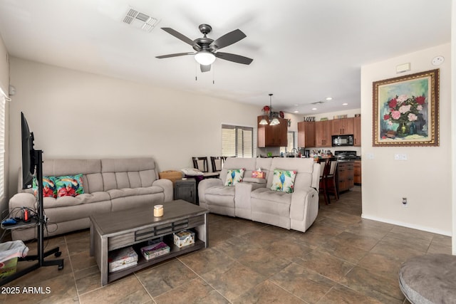 40904 N Hearst Dr, Anthem, AZ 85086 - living area featuring visible vents, baseboards, and a ceiling fan