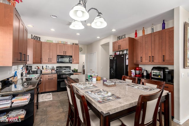 40904 N Hearst Dr, Anthem, AZ 85086 - kitchen with a sink, black appliances, pendant lighting, dark countertops, and a center island