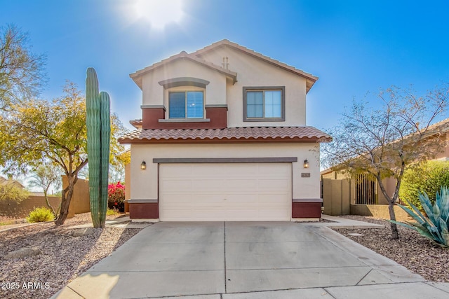 40904 N Hearst Dr, Anthem, AZ 85086 - mediterranean / spanish home featuring stucco siding, driveway, fence, a garage, and a tiled roof