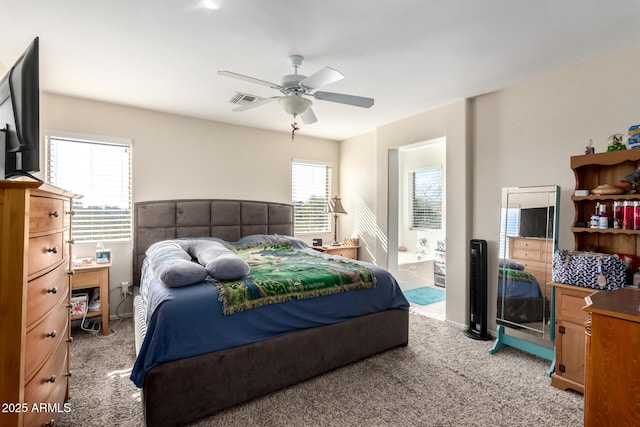 40904 N Hearst Dr, Anthem, AZ 85086 - bedroom with visible vents, baseboards, ceiling fan, light colored carpet, and ensuite bathroom