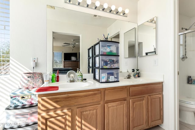 40904 N Hearst Dr, Anthem, AZ 85086 - ensuite bathroom featuring toilet, a shower with door, ensuite bath, double vanity, and ceiling fan