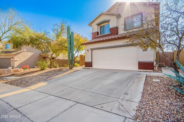 40904 N Hearst Dr, Anthem, AZ 85086 - view of front of house with fence, an attached garage, stucco siding, concrete driveway, and a tiled roof
