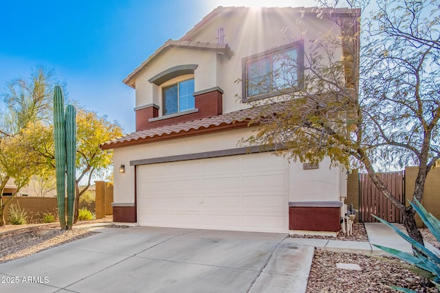 40904 N Hearst Dr, Anthem, AZ 85086 - view of front of house featuring stucco siding, an attached garage, driveway, and fence