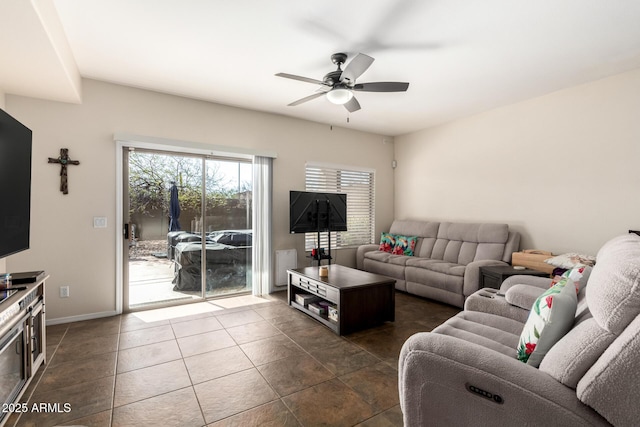 40904 N Hearst Dr, Anthem, AZ 85086 - living area with dark tile patterned floors, baseboards, and ceiling fan