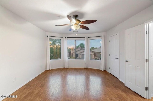 spare room featuring ceiling fan and light hardwood / wood-style floors