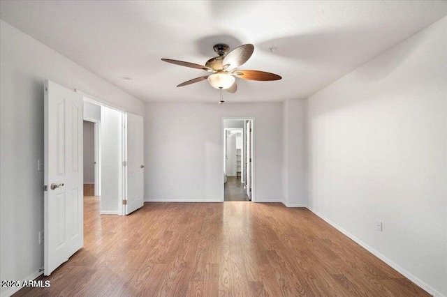 spare room featuring ceiling fan and light hardwood / wood-style floors