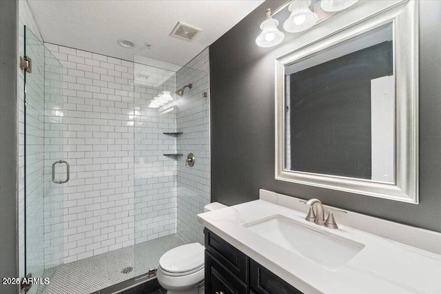 bathroom with vanity, an enclosed shower, and toilet