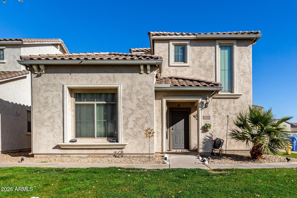 mediterranean / spanish-style home featuring a front lawn