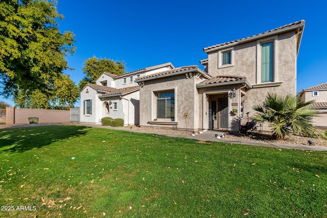 mediterranean / spanish-style home with a front lawn