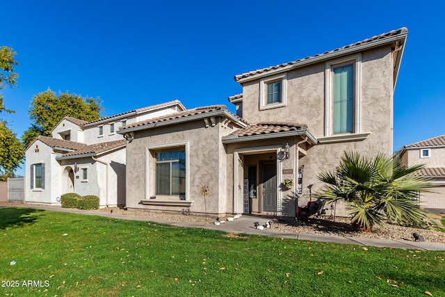 mediterranean / spanish house featuring a front yard