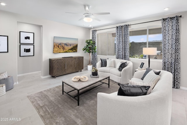 living room with ceiling fan and light hardwood / wood-style floors