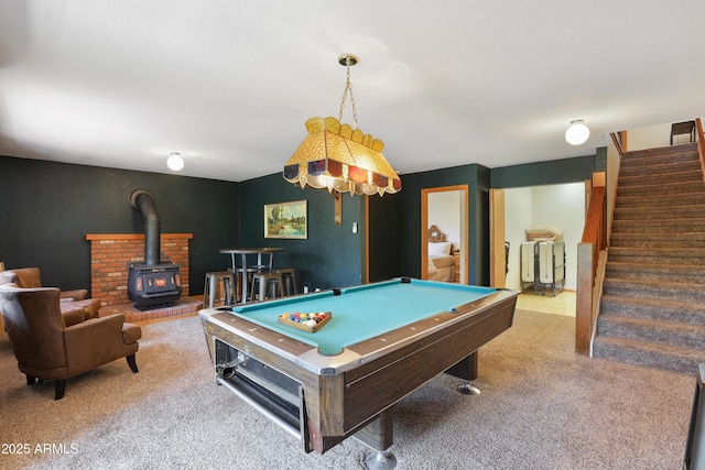 recreation room featuring pool table, carpet, and a wood stove