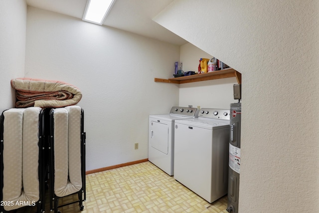 laundry room with laundry area, washing machine and dryer, water heater, and baseboards