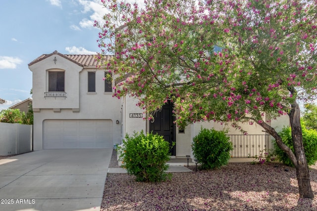 4135 E Waterman Ct, Gilbert, AZ 85297 - mediterranean / spanish home featuring stucco siding, an attached garage, driveway, fence, and a tile roof