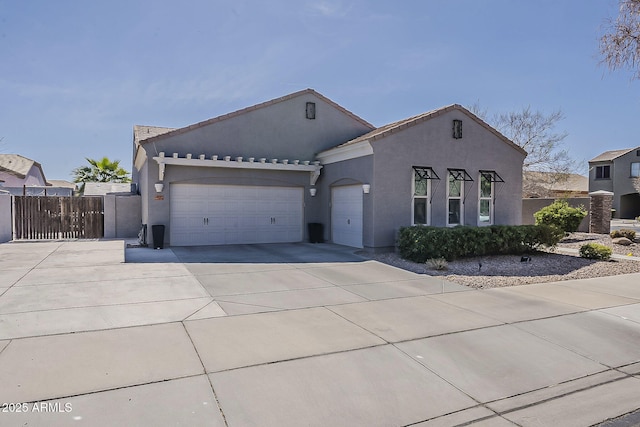 ranch-style house featuring driveway, an attached garage, a gate, fence, and stucco siding