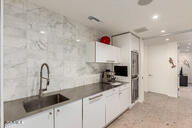 kitchen featuring a sink, white cabinetry, and recessed lighting