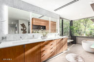 bathroom featuring a soaking tub and vanity