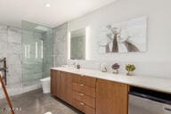 bathroom with a stall shower and vanity