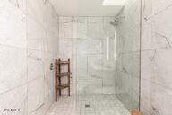 bathroom featuring a tile shower