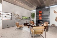living room featuring a fireplace and concrete flooring