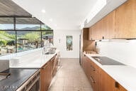 kitchen with brown cabinetry, recessed lighting, and light countertops