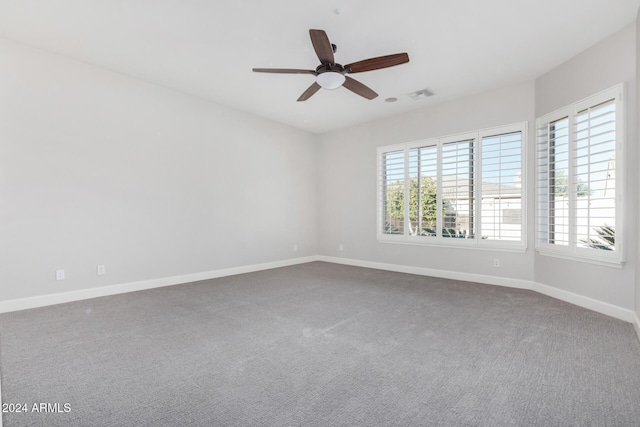 empty room with carpet, ceiling fan, and a wealth of natural light