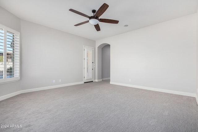 spare room featuring carpet flooring and ceiling fan