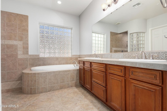 bathroom with tile patterned floors, vanity, and independent shower and bath