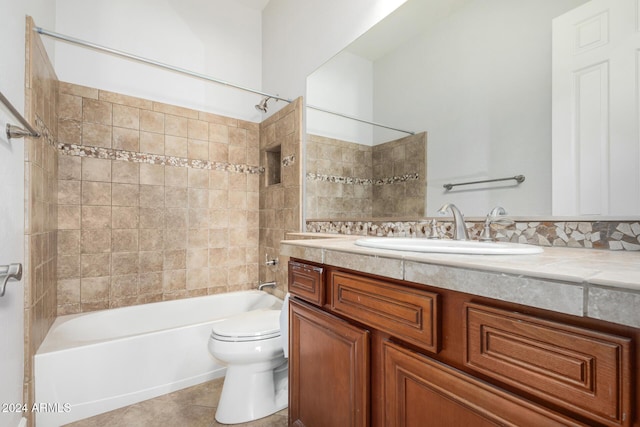 full bathroom featuring tile patterned floors, vanity, tiled shower / bath combo, and toilet