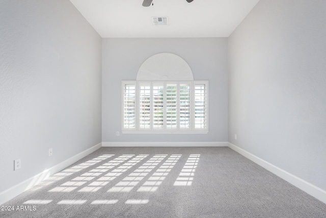 empty room featuring carpet flooring and ceiling fan