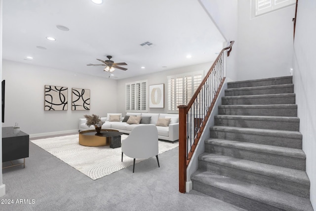 carpeted living room featuring ceiling fan