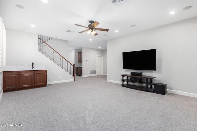 living room featuring light colored carpet and ceiling fan