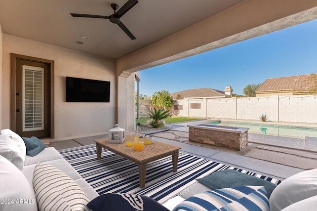 view of patio / terrace with an outdoor hangout area, ceiling fan, and a pool with hot tub