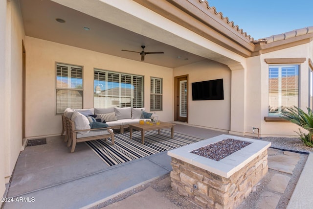 view of patio / terrace featuring an outdoor living space with a fire pit