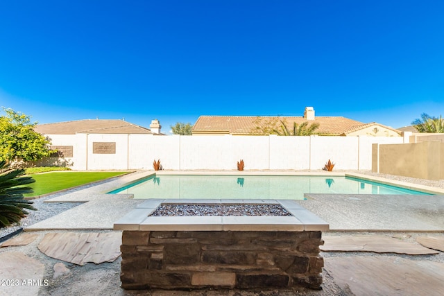 view of swimming pool featuring an outdoor fire pit