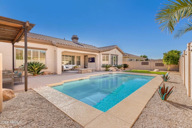 view of pool with an outdoor living space and a patio area