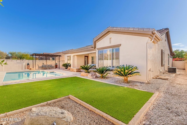 rear view of house with a fenced in pool, a pergola, a lawn, and cooling unit