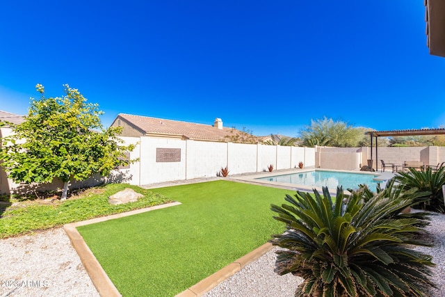 view of yard with a fenced in pool