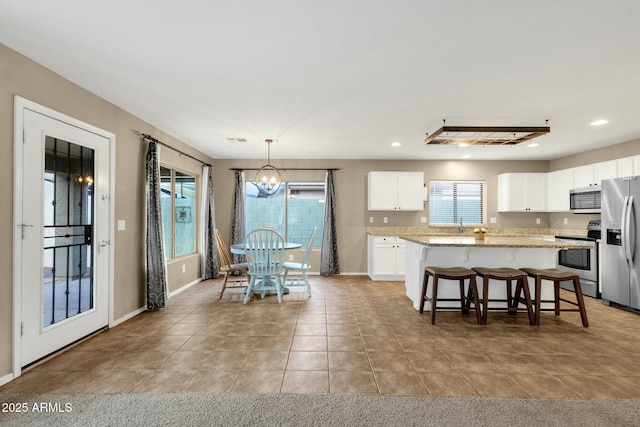 dining room with an inviting chandelier, light tile patterned floors, recessed lighting, and baseboards