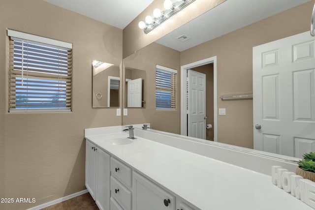 bathroom with vanity, tile patterned floors, visible vents, and baseboards