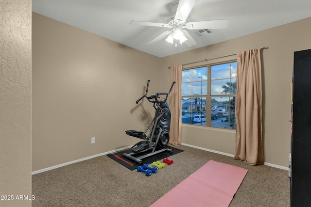 exercise room with baseboards, carpet floors, visible vents, and ceiling fan