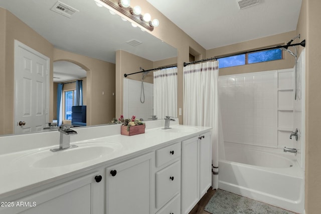 full bathroom with visible vents and a sink