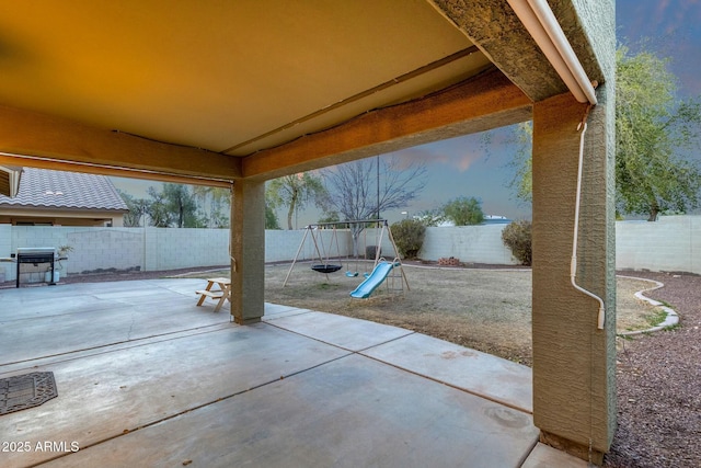 view of patio / terrace featuring a fenced backyard and a playground